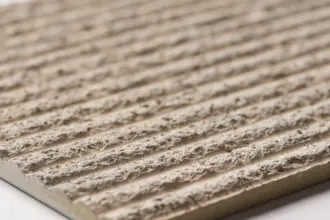 Artstone | Close-up of the Heebon decorative 3D wall panel with deep grooves and a natural beige travertine-look texture